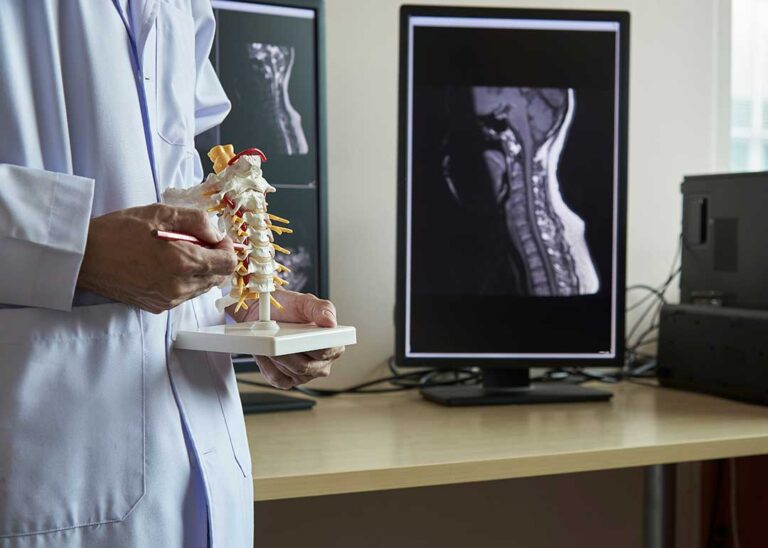 A patient discusses back pain with a chiropractor during a seated health assessment.