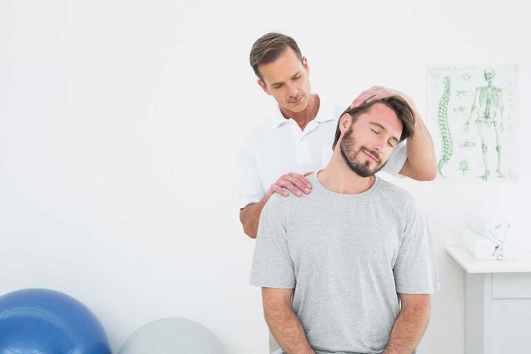 A chiropractor performing a spinal adjustment on an adult patient in a clinical setting.